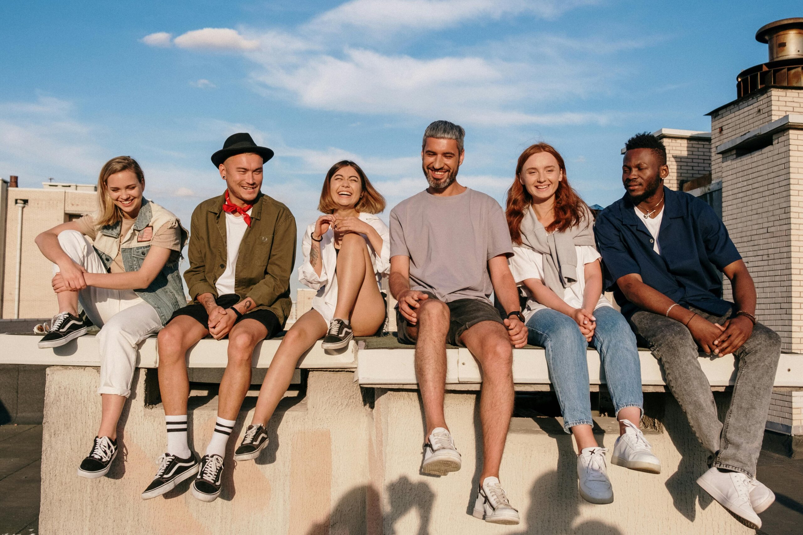 people sitting on a bench and hanging out.